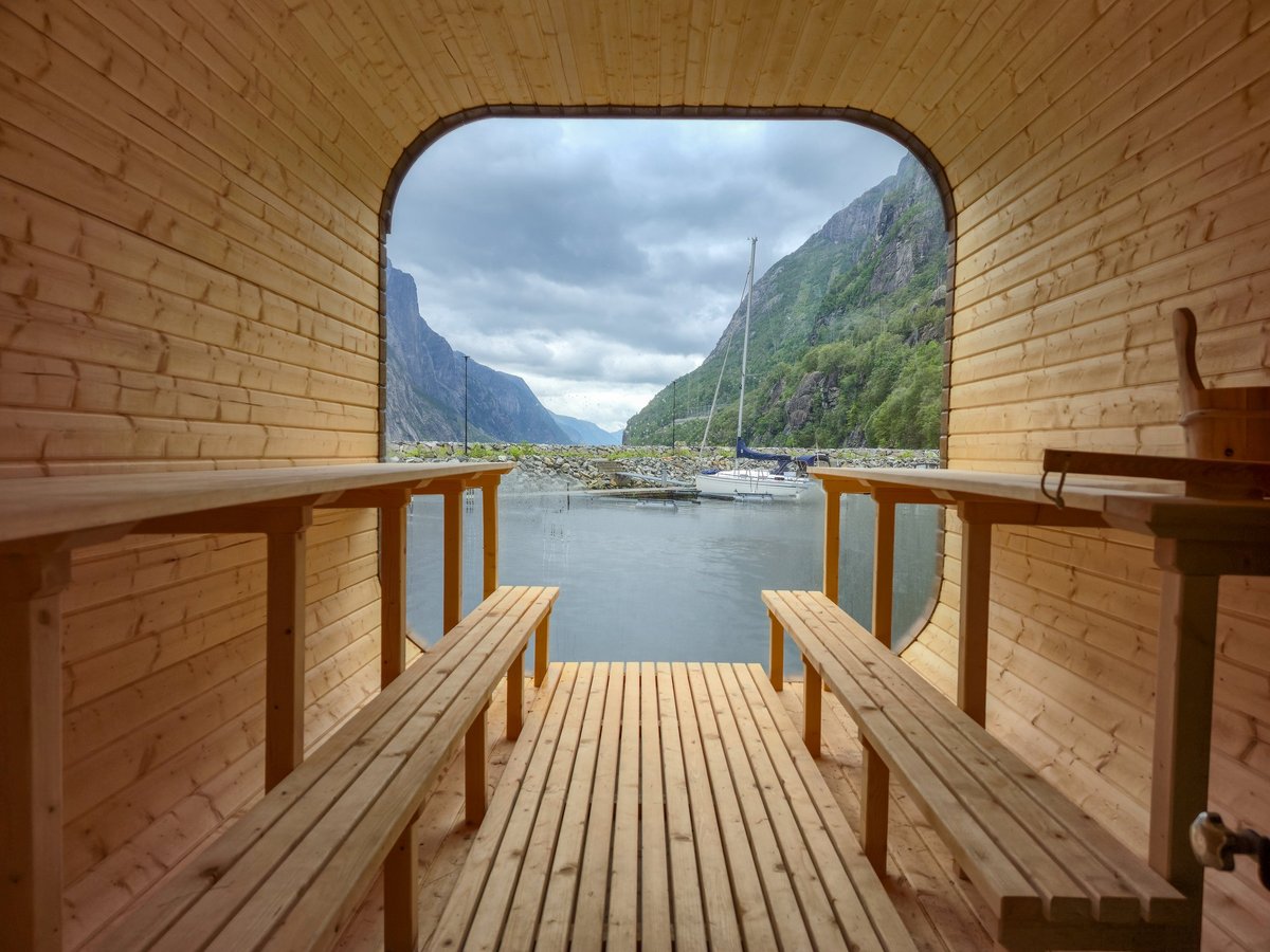 Sauna cabin interior with benches facing a scenic view